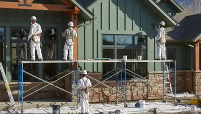 Salt Lake City painting contractors applying interior paint on a residential wall